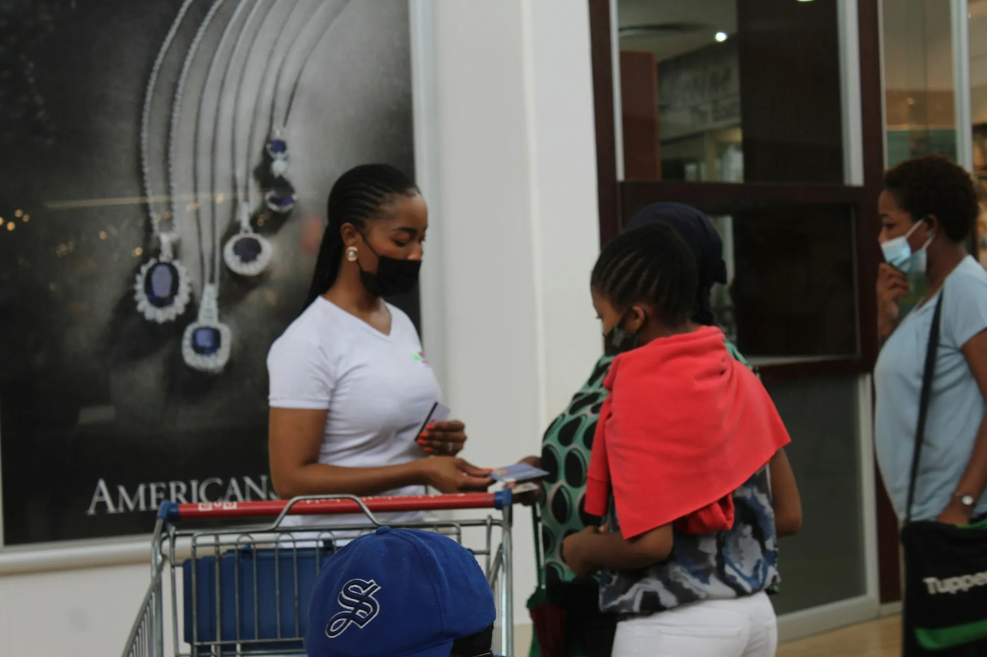 A shopper moving through a supermarket aisle